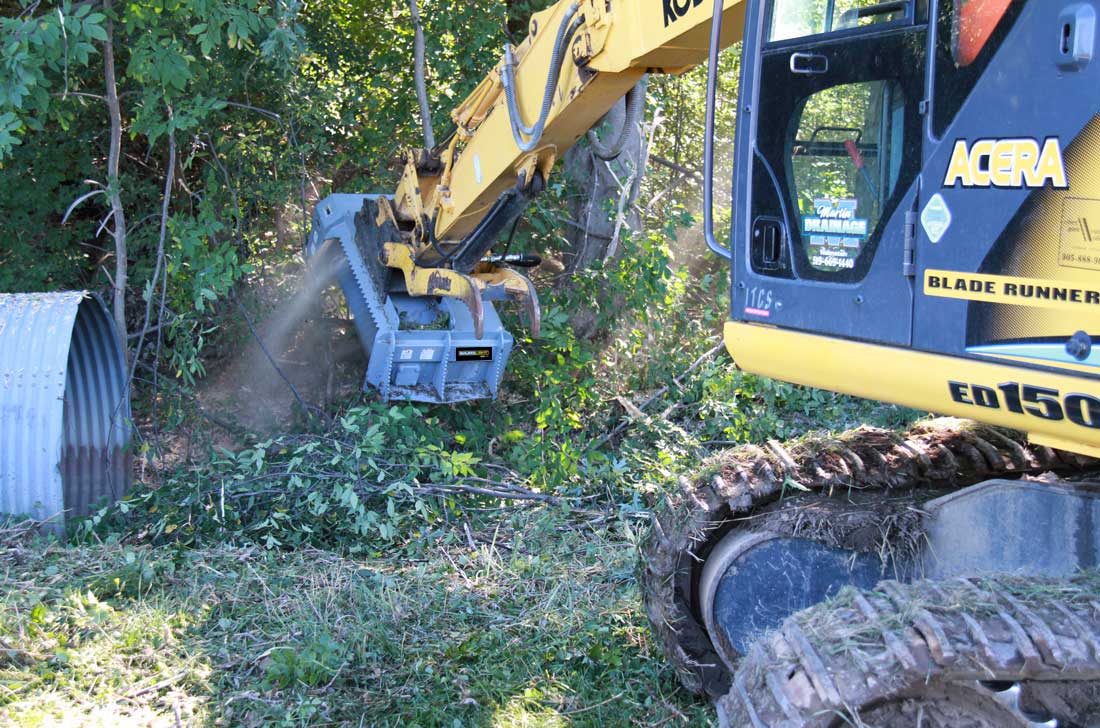 Ditch clearing with brush mulcher on excavator
