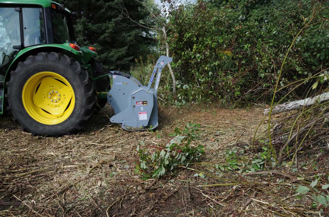 Land clearing with mulcher on tractor