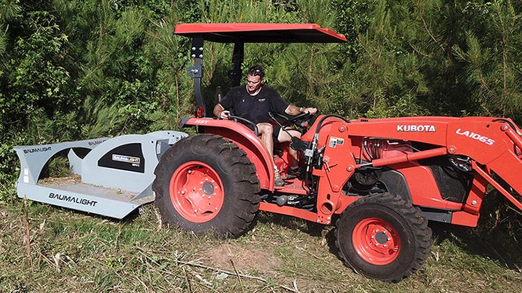Baumalight rotary brush mower mounted on tractor