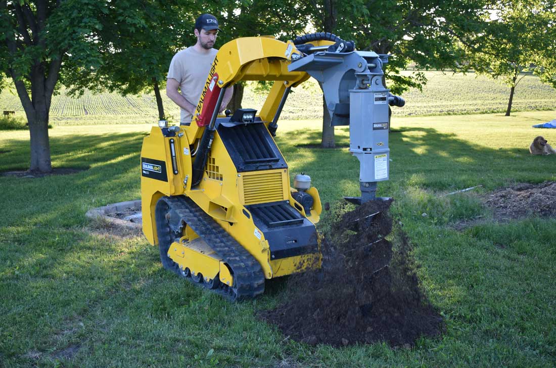 Baumalight auger drive for Mini track loader in drilling action