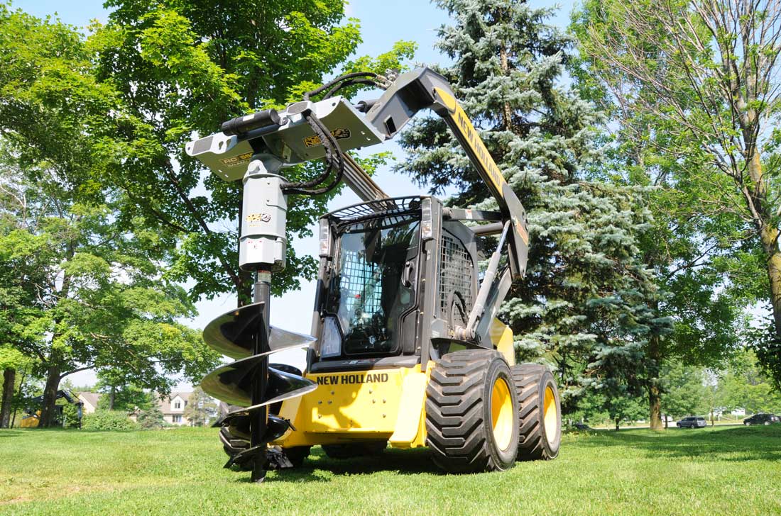 Tree auger on L185 New Holland