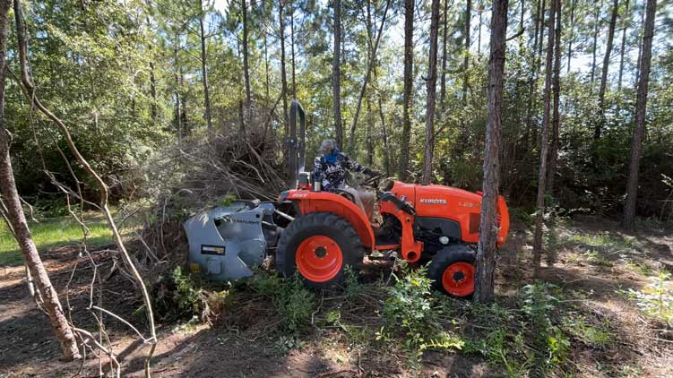 mp348 tractor mulching brush in field