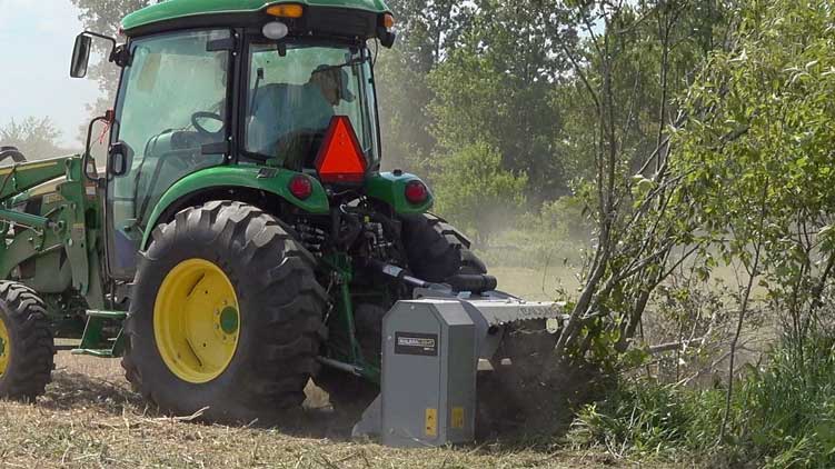 Brush mulcher mulching down bush