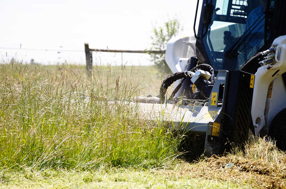 feb700 clearing long grass on field