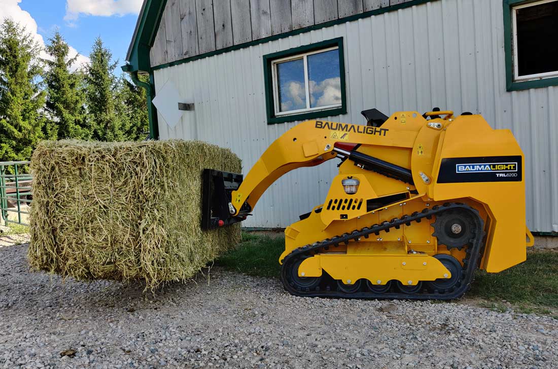 Bale spear on tracked mini skidsteer